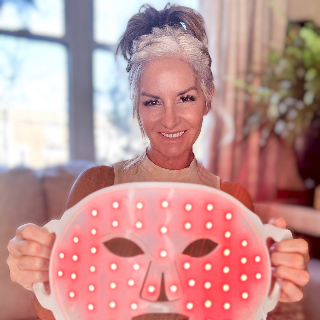 A woman is holding a face mask in front of her, showing the inner part of the face mask